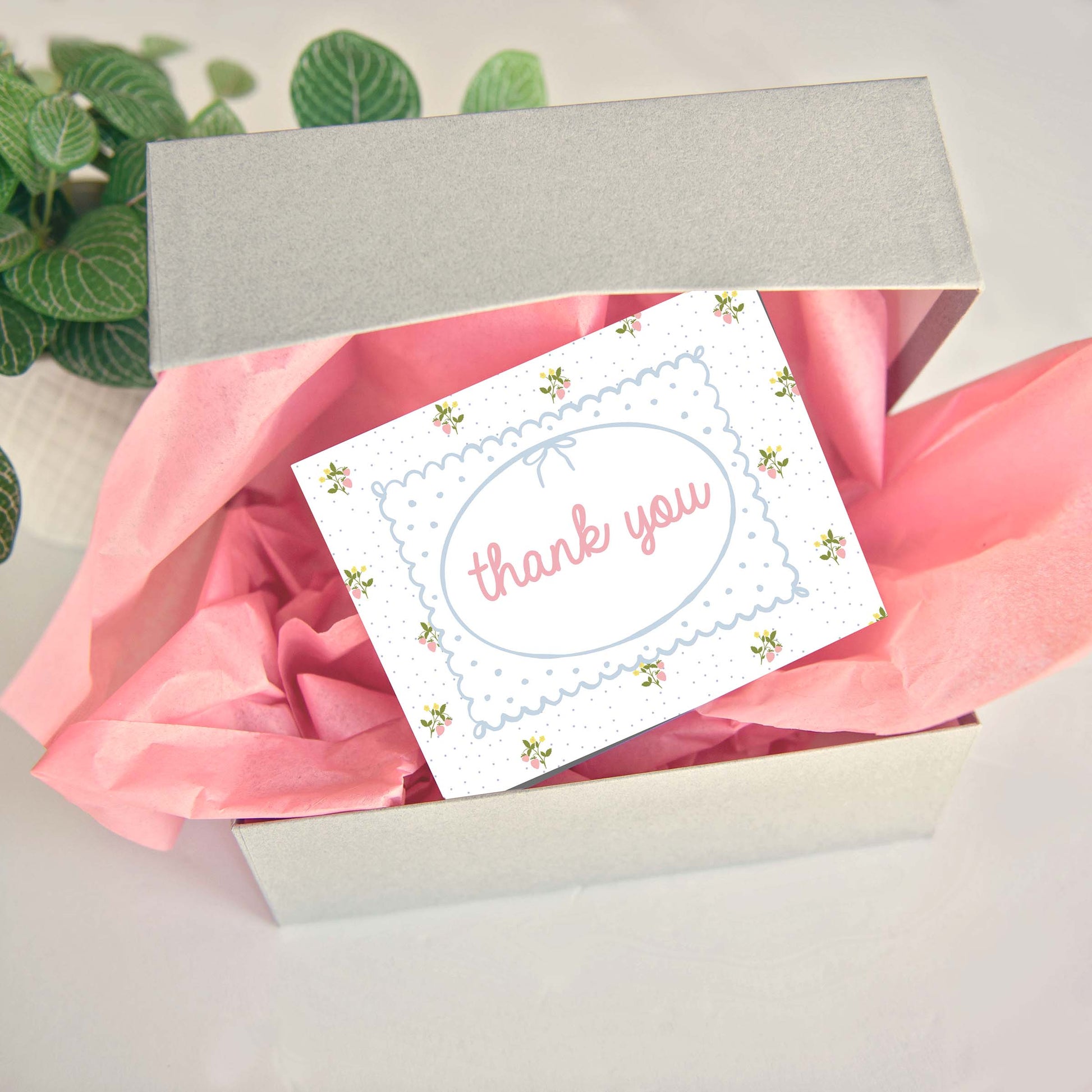 customer thank you business cards in cute coquette pattern of strawberry sprigs and tiny polka dots.  Front of customer thank you card says thank you in pink with hand drawn frame and bow.