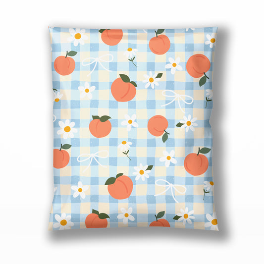 A small business poly mailer shipping envelope featuring a light blue and cream gingham pattern with orange peaches, white daisies, and white bows in 10x13, 14x19, or 6x9.