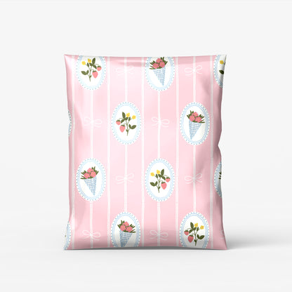 cute pink coquet poly mailers with hand drawn flower bouquets and strawberries with white bows for boutique and small business shipping and packaging customer orders