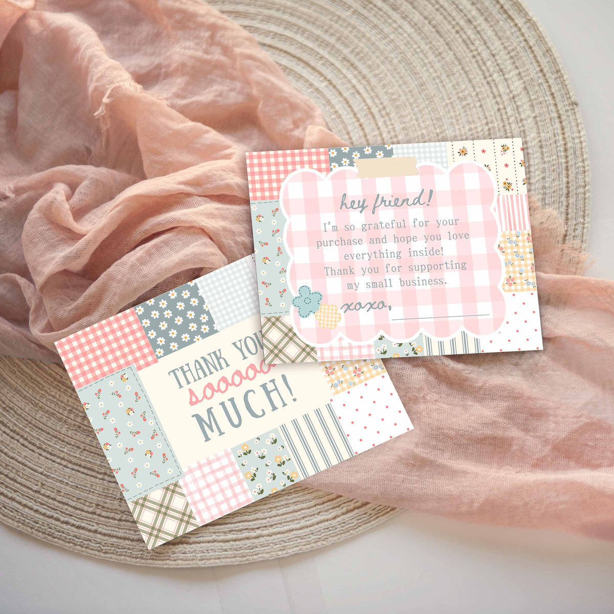 Two customer thank you message thank-you cards front and back with a patchwork design in pastel pink, blue, green, and yellow, styled on a woven placemat with draped pink fabric.  Front says thank you sooooo much!  Back has a thank you for supporting my small business message.